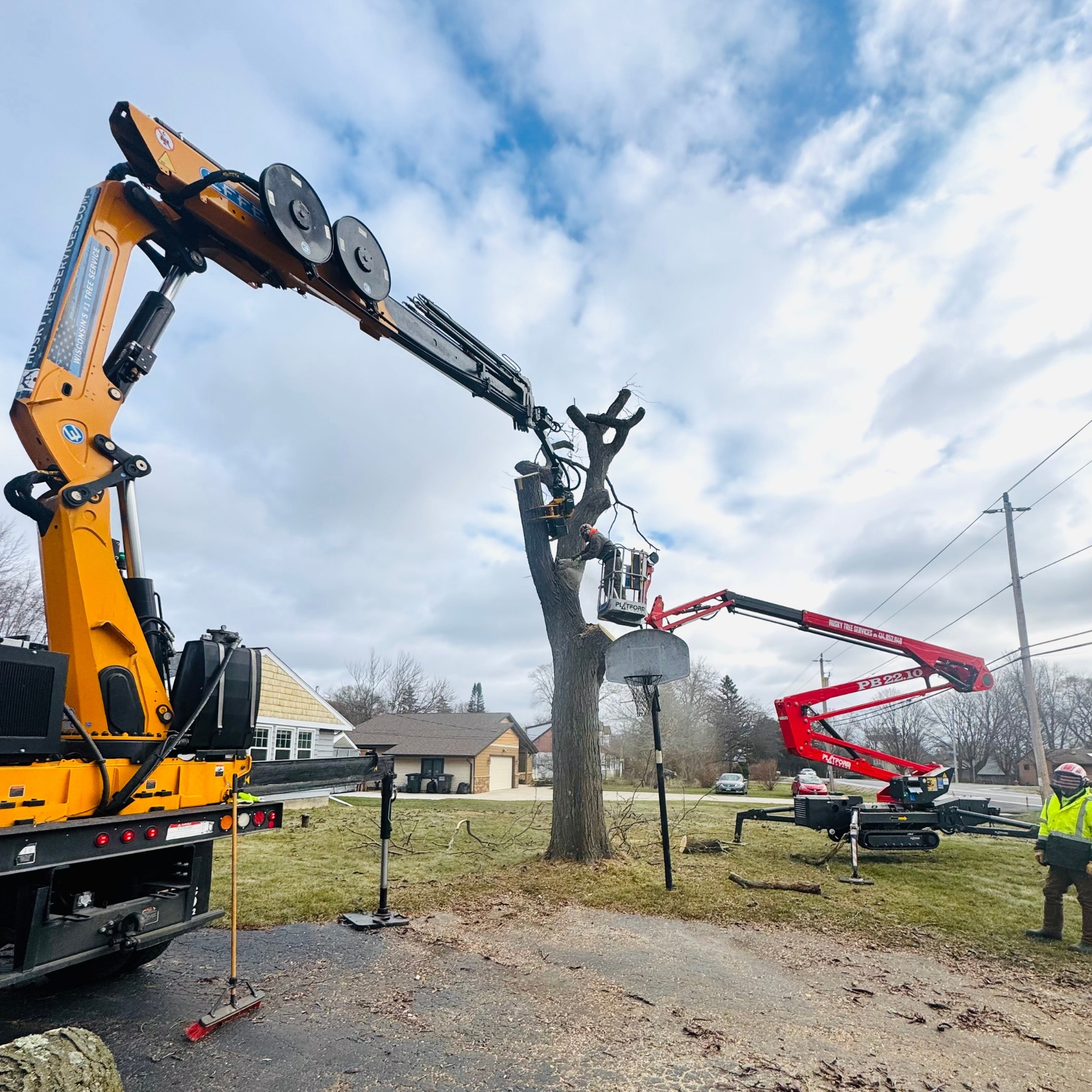 Husky Tree Services crew performing tree removal in Muskego, WI